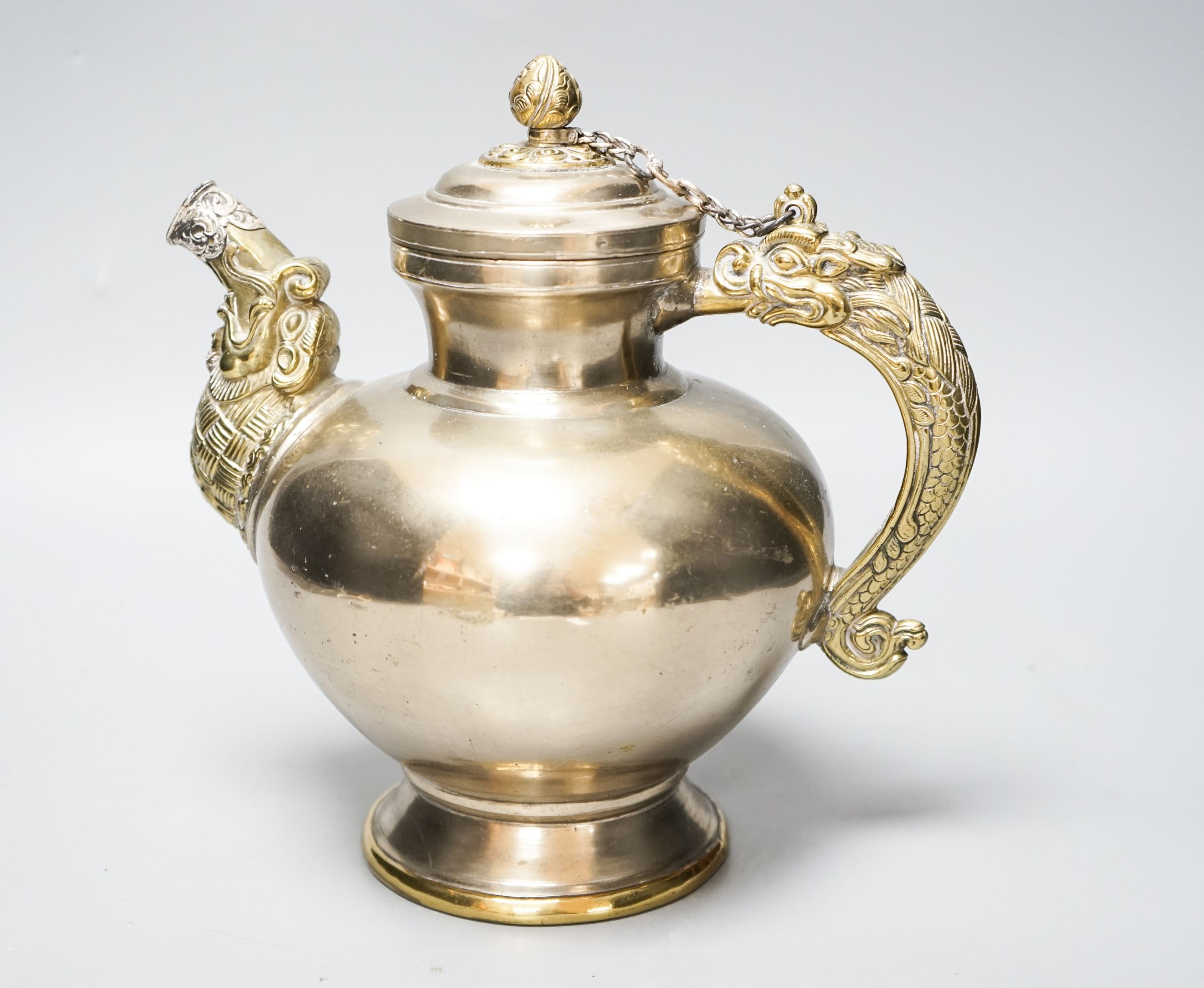 A late 19th/early 20th century Tibetan paktong, bronze and silver mounted teapot, 24cm